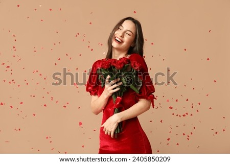 Beautiful young woman with bouquet of red roses and confetti on brown background. Valentine's Day celebration
