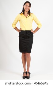 Beautiful young woman in business blouse and skirt
