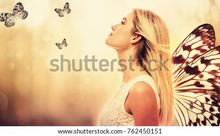 Beautiful young woman with butterfly wings on her back