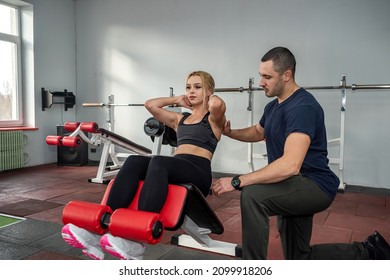 A Beautiful Young Woman Came To The Gym To Pump Up A Belly Press From A Qualified Trainer. The Concept Of Training In The Hall With A Coach