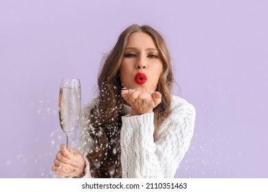 Beautiful young woman with  champagne blowing kiss on color background - Powered by Shutterstock