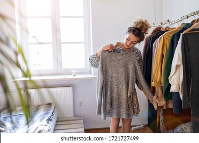 Beautiful Young Woman Choosing Clothes
