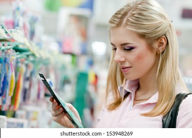 Beautiful Young Woman Choosing Tooth Brush