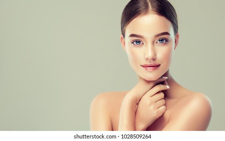 Beautiful young woman with clean fresh skin. Girl beauty face care. Facial treatment. - Shutterstock ID 1028509264