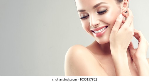 Beautiful young woman with clean fresh skin  .Girl  beauty face care. Facial  treatment   .