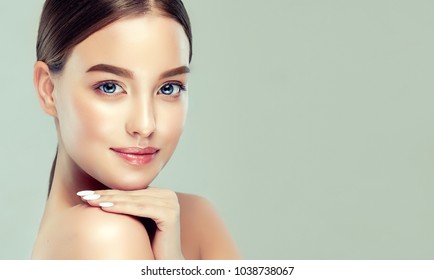 Beautiful young woman with clean fresh skin. Girl beauty face care. Facial treatment.