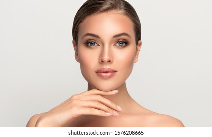 Beautiful Young Woman With Clean Fresh Skin On Face . Girl Facial  Treatment   . Cosmetology , Beauty  And Spa .
