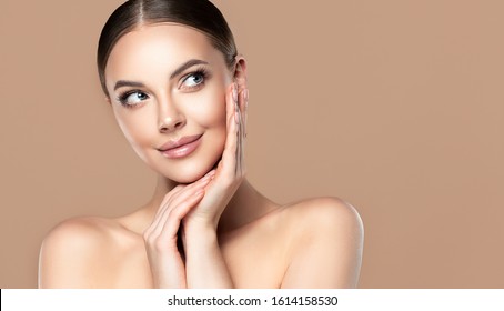 Beautiful young woman with clean fresh skin touching her face . Girl facial  treatment   . Cosmetology , beauty  and spa . Female  model, care concept - Shutterstock ID 1614158530