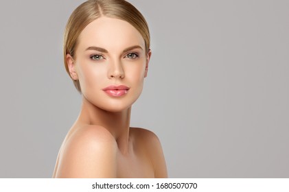 Beautiful young woman with clean fresh skin on face . Girl facial  treatment   . Cosmetology , beauty  and spa .
