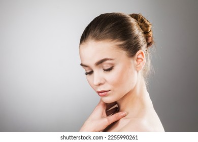 Beautiful Young Woman with Clean Fresh Skin touch own face . Facial treatment . Cosmetology , beauty and spa . - Shutterstock ID 2255990261