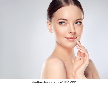 Beautiful Young Woman with Clean Fresh Skin look away  .Girl beauty face care. Facial  treatment   . Cosmetology , beauty  and spa . - Shutterstock ID 618265331