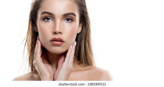 Beautiful young woman with clean perfect skin and wet glossy lips. Portrait of beauty model with natural make up, lifted brows  and long eyelashes.  Spa, skincare and wellness.