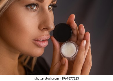 Beautiful Young Woman With Clean Perfect Skin Uses Lips Sugar Scrub. Spa, Skincare And Wellness. Close Up