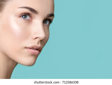 Beautiful Young Woman With Clean Perfect Skin Looking Up. Portrait Of Beauty Model With Natural Nude Make Up And Long Eyelashes. Spa, Skincare And Wellness. Close Up, Background, Copyspace. 