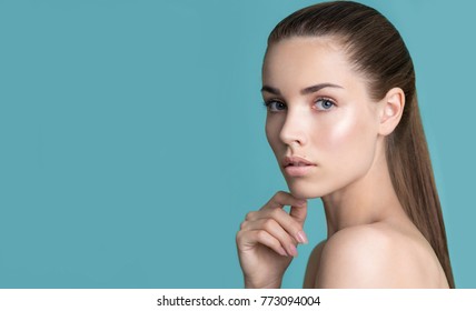 Beautiful Young Woman With Clean Perfect Skin And Hand With Manicure Touching Face. Portrait Of Beauty Model With Natural Nude Make Up. Spa, Skincare And Wellness. Close Up, Background, Copyspace.