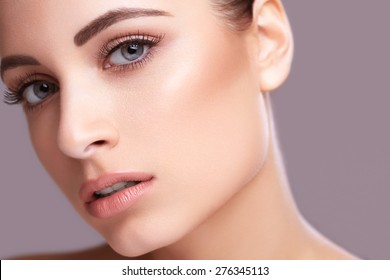 Beautiful Young Woman With Clean Skin Of The Face. Skin Care