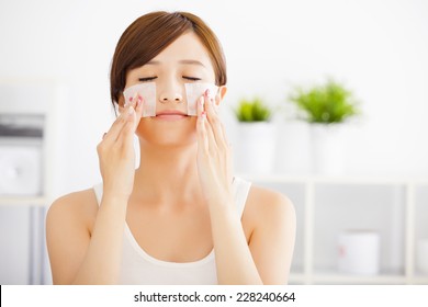 Beautiful  Young Woman Cleaning Her Face With Cotton