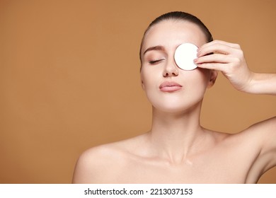 Beautiful Young Woman Close One Eye With White Cotton Pad