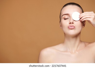 Beautiful Young Woman Close One Eye With White Cotton Pad