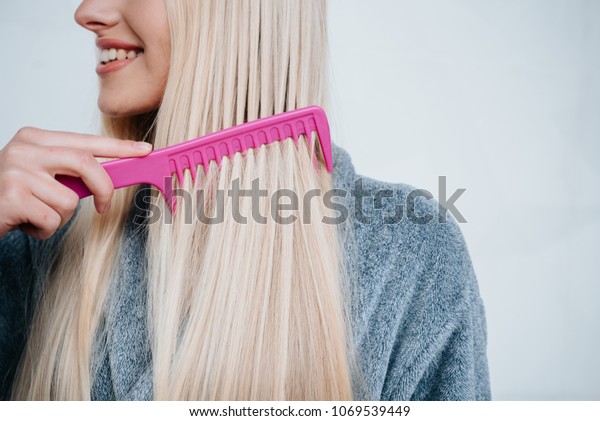 Beautiful Young Woman Combing Her Hair Stock Photo Edit Now