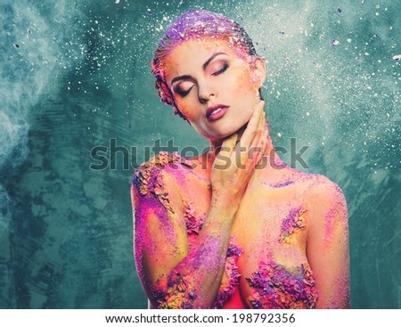 Beautiful young woman with conceptual colourful body art 