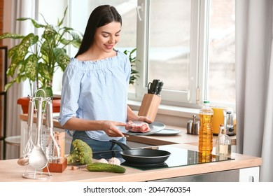 Beautiful Young Woman Cooking In Kitchen