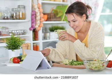 beautiful young woman cooking  in kitchen - Shutterstock ID 2188891837