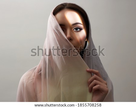 beautiful young woman covered her face. beauty woman in sunlight. fashion oriental style woman. ethnic people