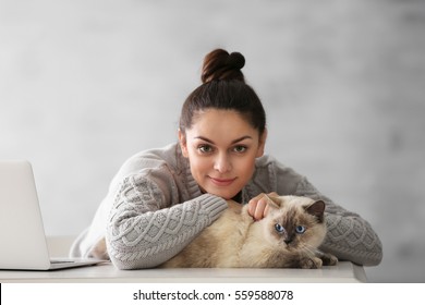 Beautiful Young Woman With Cute Cat On Grey Background