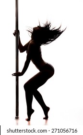 Beautiful young woman dancing at pole