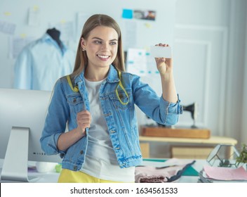 Beautiful young woman designer with business card in office - Shutterstock ID 1634561533