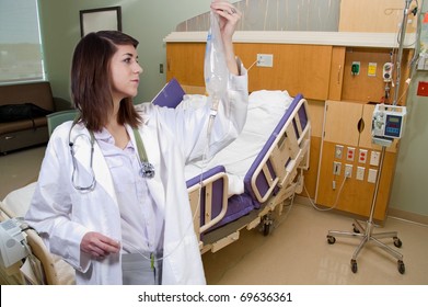 A Beautiful Young Woman Doctor Holding An IV Bag