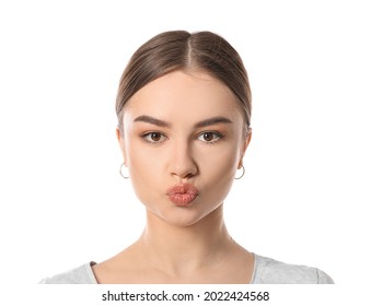 Beautiful Young Woman Doing Facial Yoga On White Background