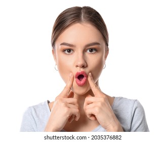 Beautiful Young Woman Doing Facial Yoga On White Background