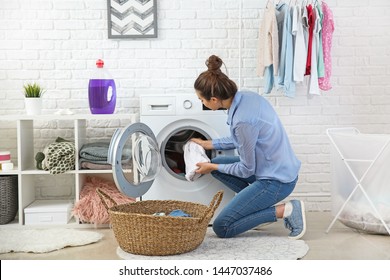 Beautiful Young Woman Doing Laundry At Home