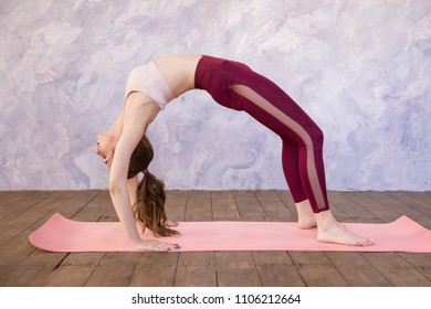 Beautiful Young Woman, Doing Yoga Exercise, Stretching, Standing In Bridge Pose, Urdhva Dhanurasana (Upward Bow), Chakrasana (Wheel) Posture, Full Length.