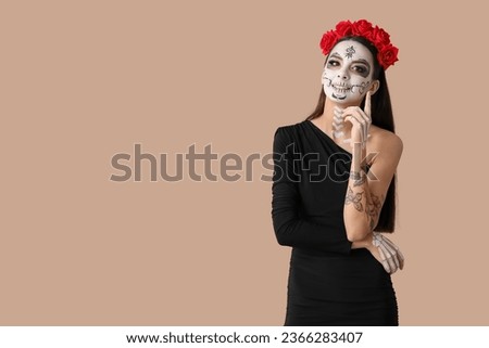 Beautiful young woman dressed as dead bride for Halloween party on beige background