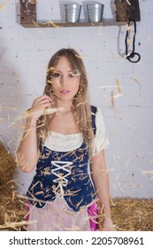 Beautiful Young Woman, Dressed In A Farmer's Outfit In The Barn Playing With The Hay Throwing It Over Her Body , Farm Trades