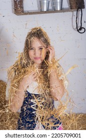 Beautiful Young Woman, Dressed In A Farmer's Outfit In The Barn Playing With The Hay Throwing It Over Her Body , Farm Trades