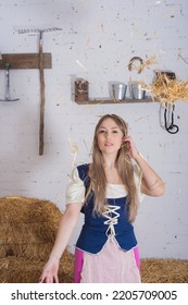 Beautiful Young Woman, Dressed In A Farmer's Outfit In The Barn Playing With The Hay Throwing It Over Her Body , Farm Trades