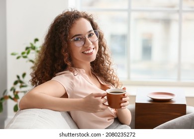 Beautiful young woman drinking coffee at home - Shutterstock ID 2080235272
