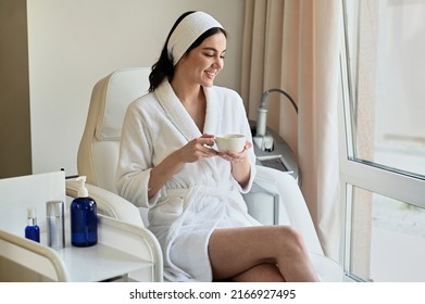 Beautiful Young Woman Drinking Coffee In A Beauty Salon On A Chair For Treatments