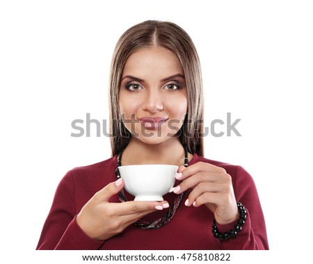Beautiful young woman drinking coffee on white background