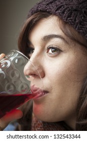 Beautiful Young Woman Drinking Glass Of Cranberry Juice