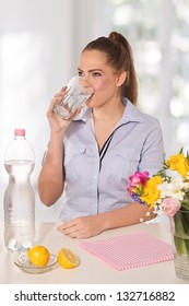 Beautiful Young Woman Drinking A Glass Of Water Witth Lemon