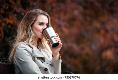 Beautiful Young Woman Drinking Hot Coffee From Thermos Cup