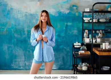 Beautiful Young Woman Drinking Morning Coffee In The Designer Kitchen At Home, Smiling, Relaxing. Copy Space. Real People Lifestyle.
                