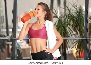 Beautiful Young Woman Drinking Protein Shake In Gym