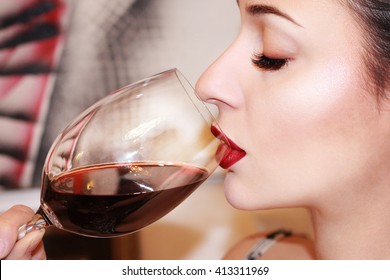 Beautiful Young Woman Drinking Red Wine