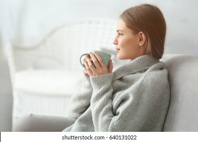 Beautiful Young Woman Drinking Tea While Resting At Home